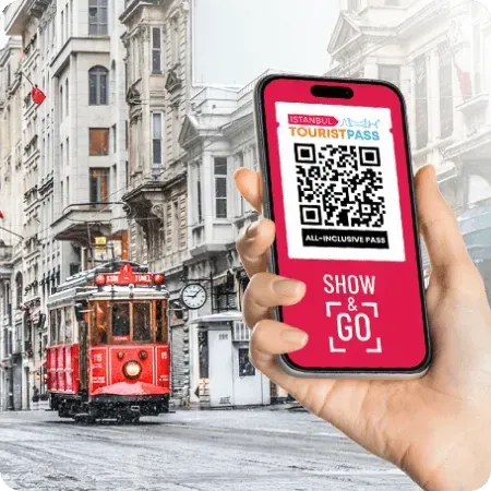 Istanbul Tourist Pass QR code on a phone, held up on Istiklal Street